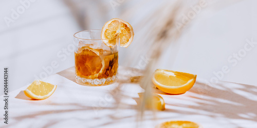 Orange cocktail still life with citrus wedges  ice and wide restaurant copy space. Concept of premium bar menu  cocktail advertising  hospitality banner  lounge promo and drink layout.