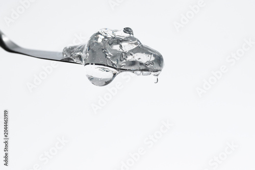 Transparent gel close-up on a neutral background, cosmetic texture.