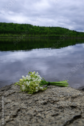Lily of the valley flower bouquet on a stone background