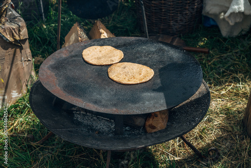 Traditional flatbreads are cooked on a comal over an open wood fire