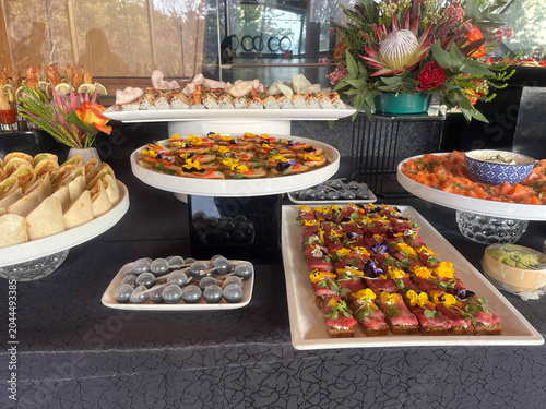 Fotografie Buffet table with various appetizers and sushi rolls.