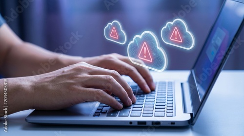 System administrator managing cloud infrastructure and server security alerts displayed as digital notification warning clouds on laptop screen with infrastructure