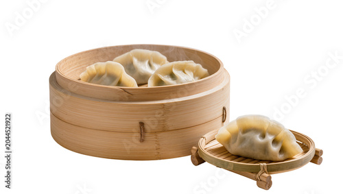 Obraz na plátne Steamed dumplings in bamboo steamer basket and on small plate