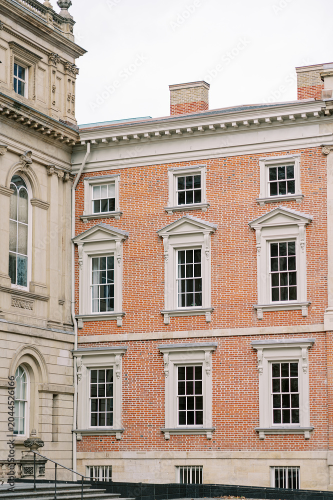 Obraz premium Traditional stone structure with decorative features. Serene street view showcasing timeless masonry and architectural details in soft daylight