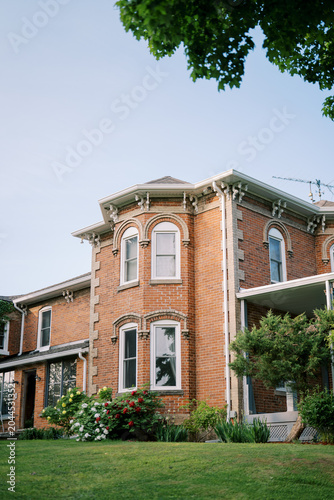 Brick townhouse with garden and tree canopy