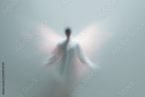 Minimal luminous guardian angel figure with translucent wings and soft blur ethereal light for background and wallpaper design