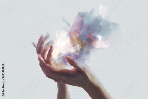 Minimal hands cupping multicolored translucent shards for abstract background and creative concept design