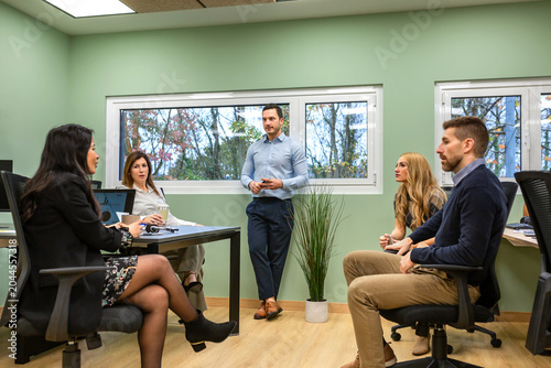 Business professionals collaborating during an informal office coffee break, sharing ideas and engaging in dynamic communication within a modern workplace environment