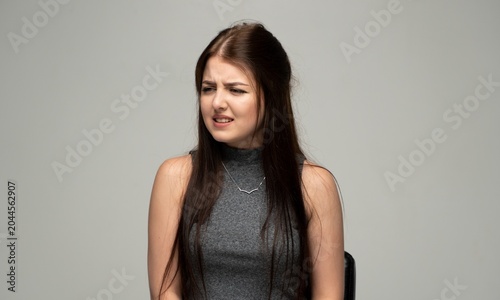 Canvas Print Young woman grimacing with a disgusted expression, feeling repulsion and aversio