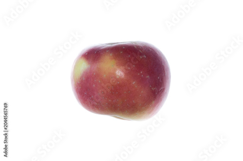 A red apple with greenish patches from the side on white background