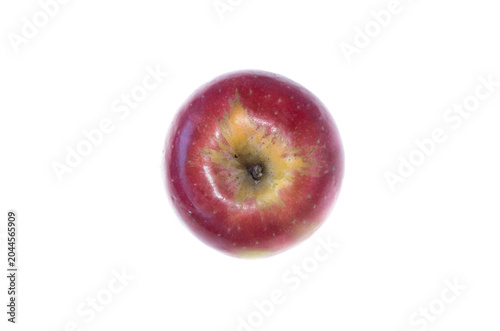 A red apple with greenish center from above on white background
