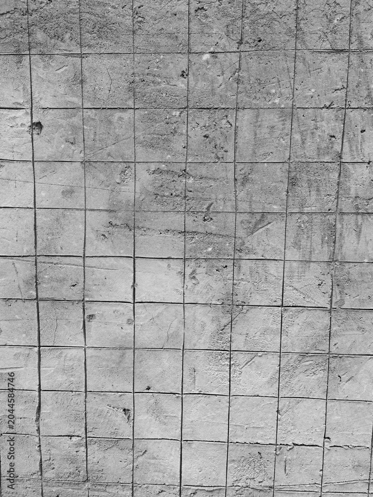 Fototapeta premium Concrete wall surface reveals grid marks and construction texture after finishing work. Concept of strength, structure, durability, and industrial development.