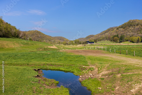 A Rural Landscape With Rolling Hills In Spring