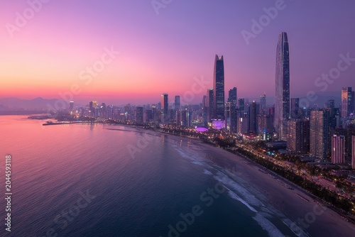 Vibrant Cityscape At Dusk Overlooking A Beach With Purple Sky And Illuminated Skyscrapers Reflecting In The Water With Gentle Waves Creating A Serene And Captivating Ambiance