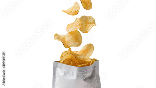 Crispy potato chips falling out of a silver bag