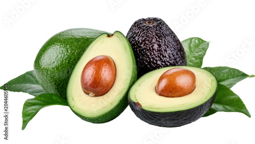 Fresh avocados whole and halved with seeds, green leaves