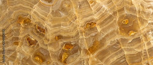 Photos Honey onyx marble slab with golden veins and amber crystal inclusions for luxury