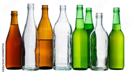Assortment of empty glass bottles in amber clear, and green colors