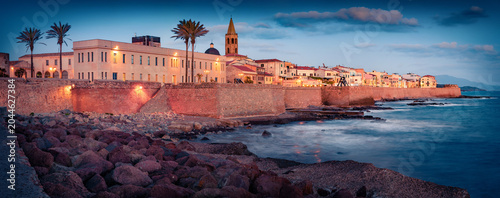 Tableau sur toile Panoramic evening cityscape of Alghero port with old fortress, Province of Sassari, Italy, Europe