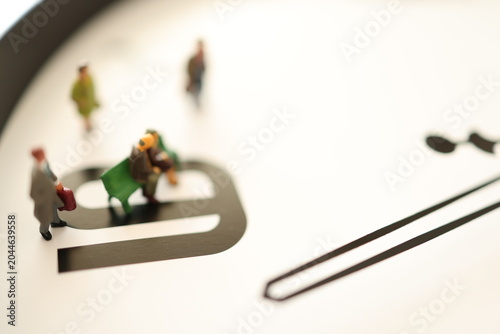 Miniature people on a clock.