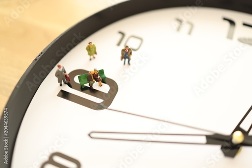 Miniature people on a clock.