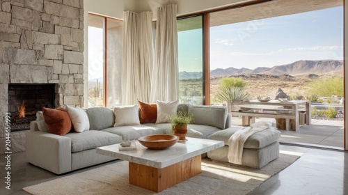 Modern living room with natural stone fireplace and desert view