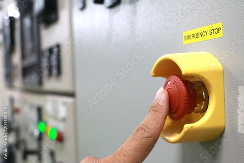Push by man Emergency button on electric room used in the factory,Emergency stop machine.	
