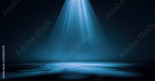 Blue spotlight beams pierce darkness onto a smoky, reflective floor