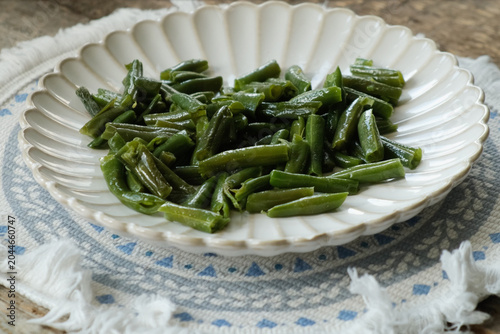 Cooked green beans on plate. Healthy vegetarian plant based meal