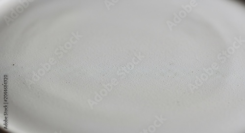 Empty white plate on table surface.