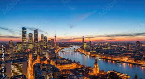 Stunning Aerial View of Frankfurt Skyline at Dusk with Illuminated Buildings.