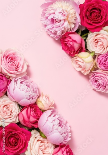Beautiful top view of pink roses and lush peonies arranged artistically on a soft pastel pink background with plenty of blank copy space, copy space, aesthetic, greeting