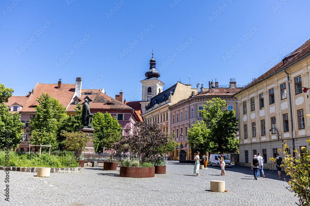 Obraz premium Historic European Town Square with Cobblestone Pavement and Clock Tower