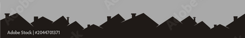 Black silhouette of house rooftops against a gray sky, urban housing