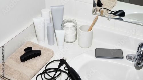 Gen Z bathroom vanity with skincare clutter cords and morning routine