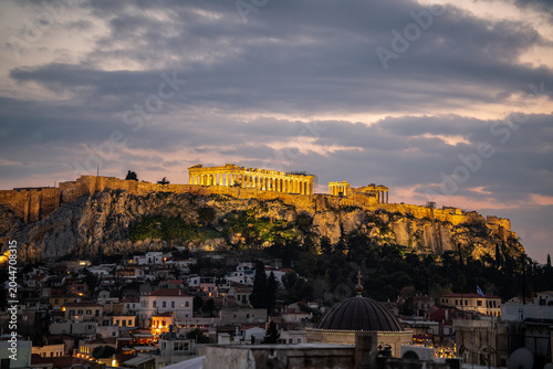 Ancient Hilltop Temple Ruins Illuminated at Dusk Overlooking Historic European Capital Cityscape