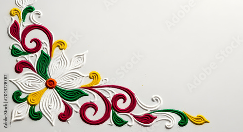 Colorful floral rangoli design element on white background.