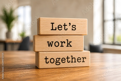 Wooden blocks with words 'Let's work together'. Business concept
