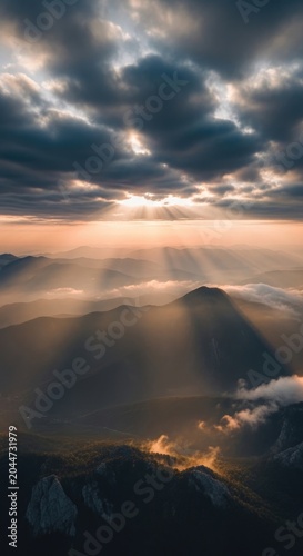 Dramatic Sunset Over Mountain Peaks with Stunning Cloud Formations.