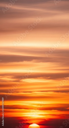 Vibrant Sunset Sky with Orange and Yellow Hues, Dramatic Clouds.