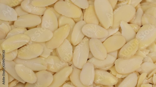 Zoom frame raw sliced almonds close up, rotation 