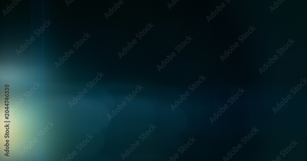 Obraz premium Anamorphic lens flare and light leak effect on dark background. Minimal cinematic optical texture ideal for overlays, film production, motion graphics and visual effects.