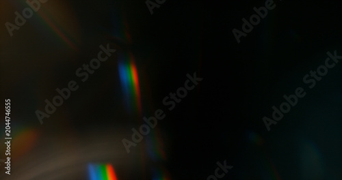 Abstract cinematic lens flare with soft bokeh circles and subtle light reflections. Atmospheric optical effect background ideal for overlays, visual effects, film production and creative design.