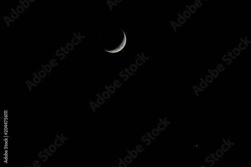 Crescent moon, star beside the moon