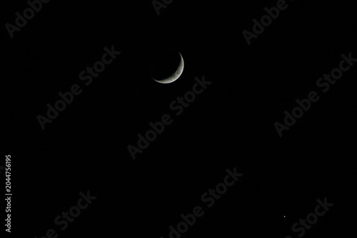 Crescent moon, star beside the moon