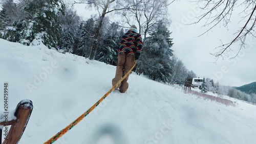 POV Teen Girl Pulling Sled Uphill on Snowy Winter Hill