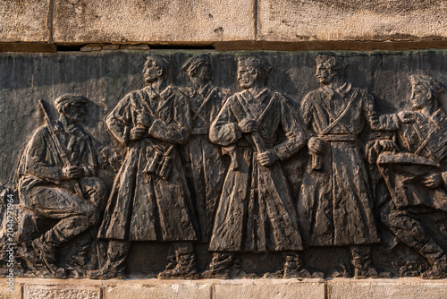 Tableau sur toile Detailed view of the bronze relief on the stone base of the Freedom Monument on Iriski Venac, Serbia