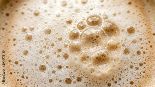 Foamy coffee surface, close-up, creamy texture, brown bubbles