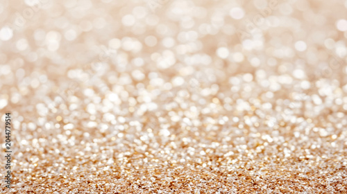 Golden sparkle particles forming textured surface with soft glowing light reflections and defocused background. Ideal for luxury backdrop, party decoration visuals and festive advertising banners