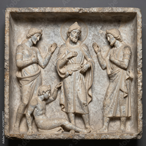 Saint Michael Weighing Souls on Judgment Day in a Romanesque Limestone Relief Carving